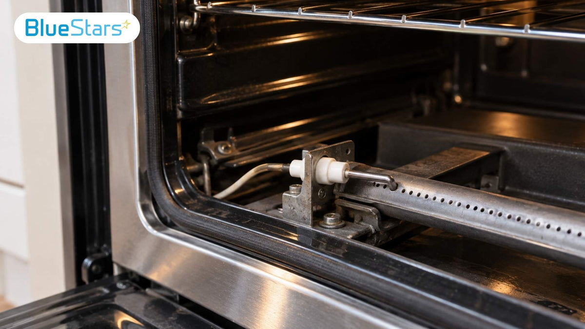 Close-up of a gas oven burner and ignition electrode inside an open oven, illustrating a gas oven not lighting issue