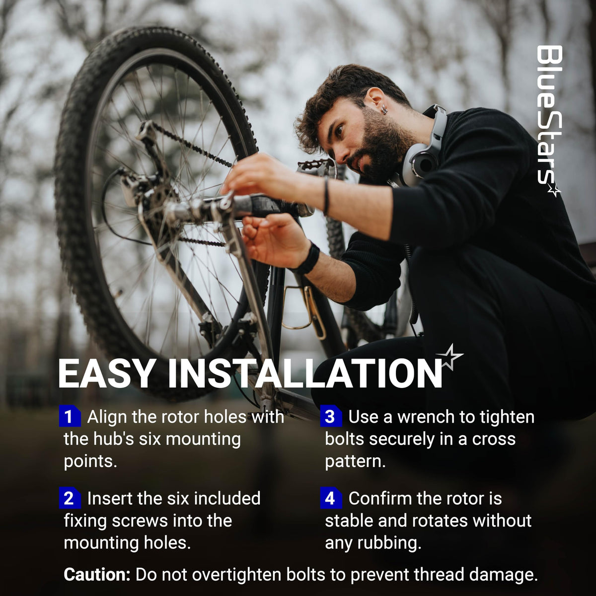 Cyclist installing a 203mm stainless steel disc brake rotor with 6 bolts on a mountain bike wheel.