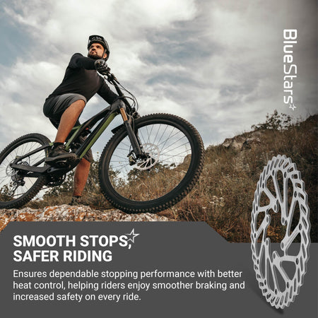 140mm stainless steel bike disc brake rotor shown next to a mountain biker on a trail.