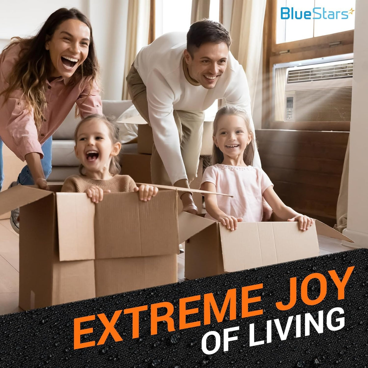 Family playing with cardboard boxes in a living room with a window air conditioner installed.