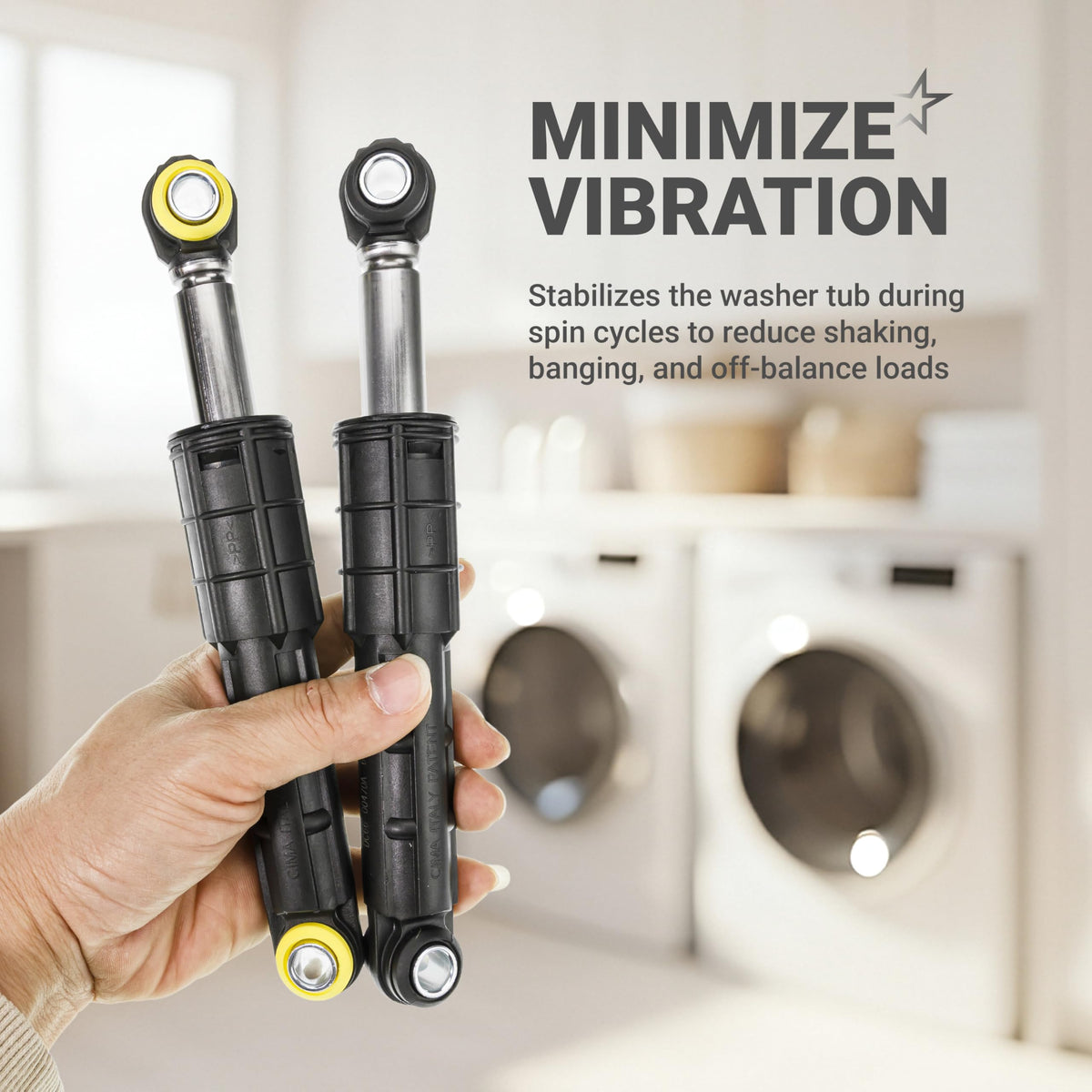 Hand holding two Samsung washing machine shock absorbers to minimize vibration and stabilize the tub.